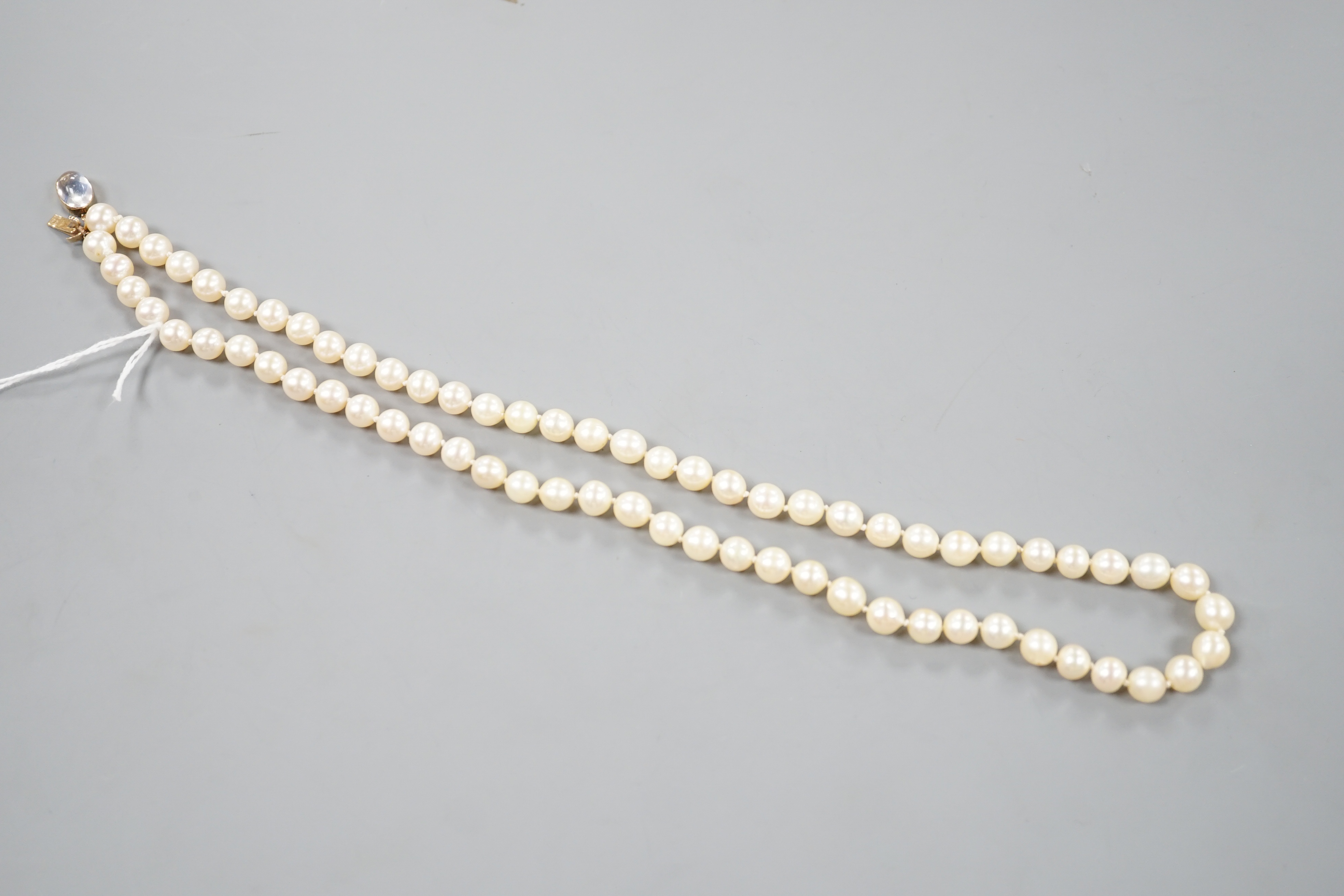 A single strand cultured pearl necklace, with yellow metal and moonstone set clasp, 56cm.